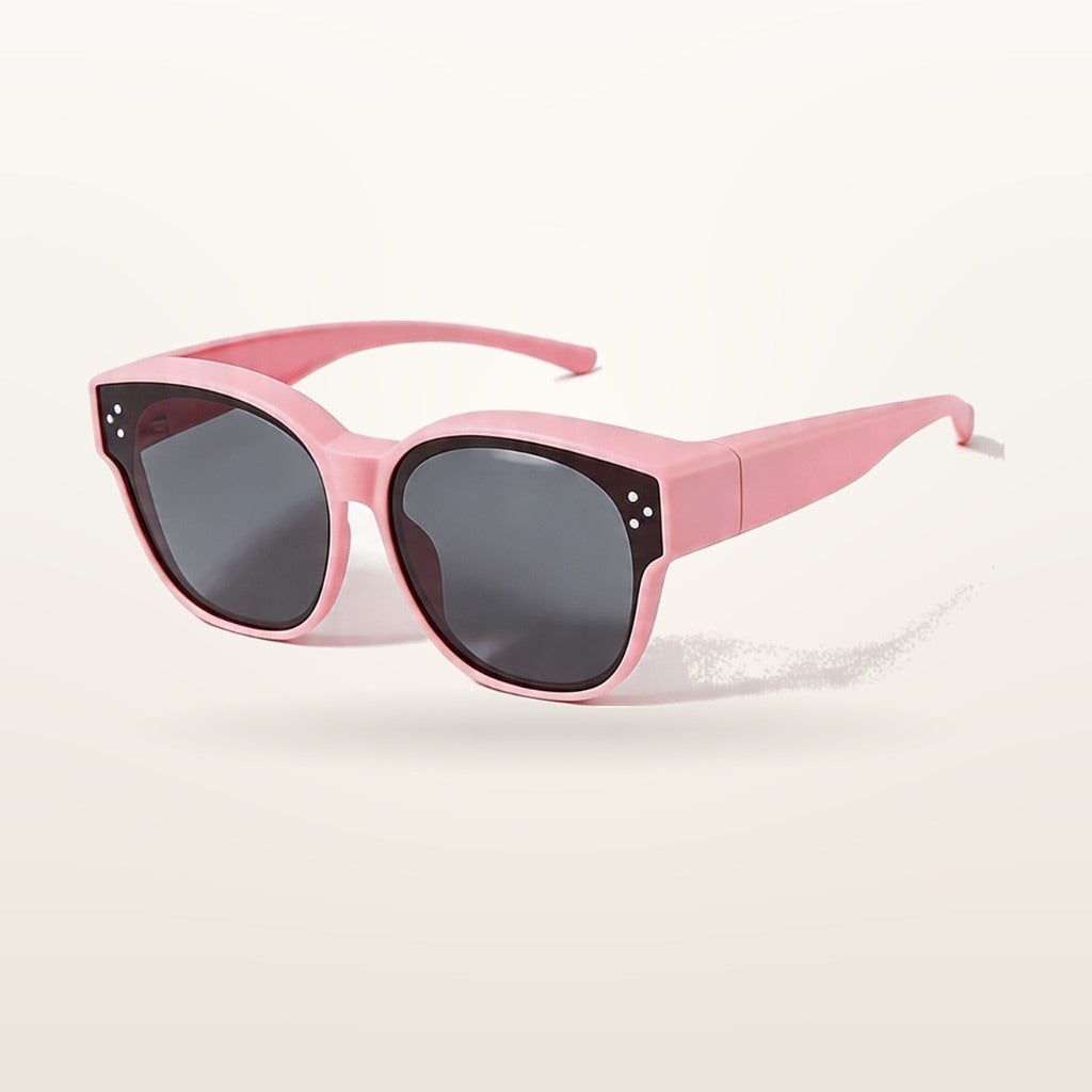 SunFit Kids fit-over sunglasses in pink, studio shot on an off-white background