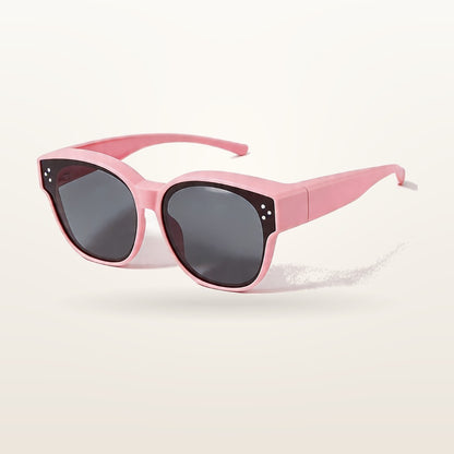 SunFit Kids fit-over sunglasses in pink, studio shot on an off-white background