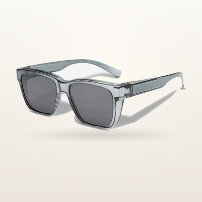 SunFit Men Classic fit-over sunglasses with a transparent grey frame, studio shot on an off-white background