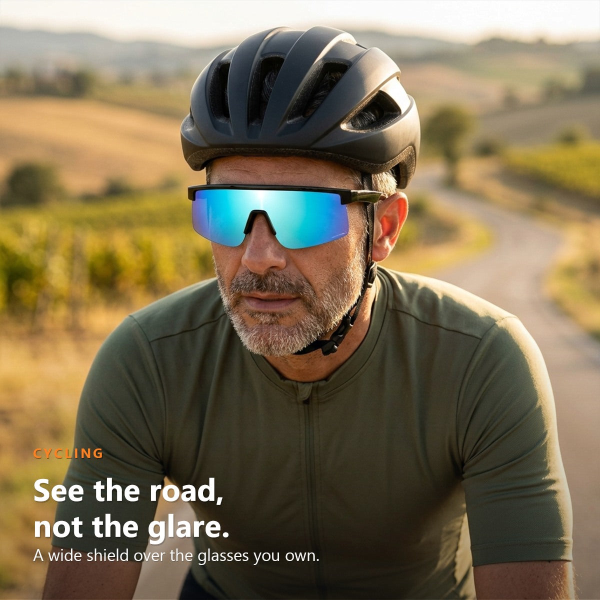 Cyclist on a country road wearing SunFit Sport Jet Blue over his glasses